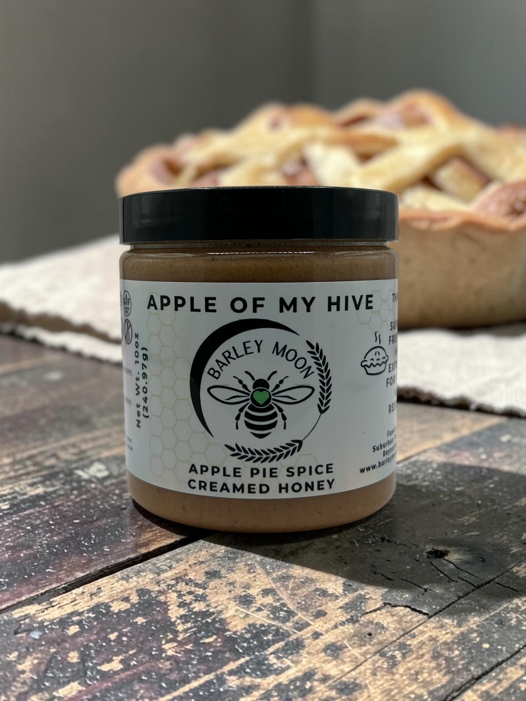 Barley Moon Botanicals Apple of My Hive creamed honey jar with apple pie spice on a rustic wooden table