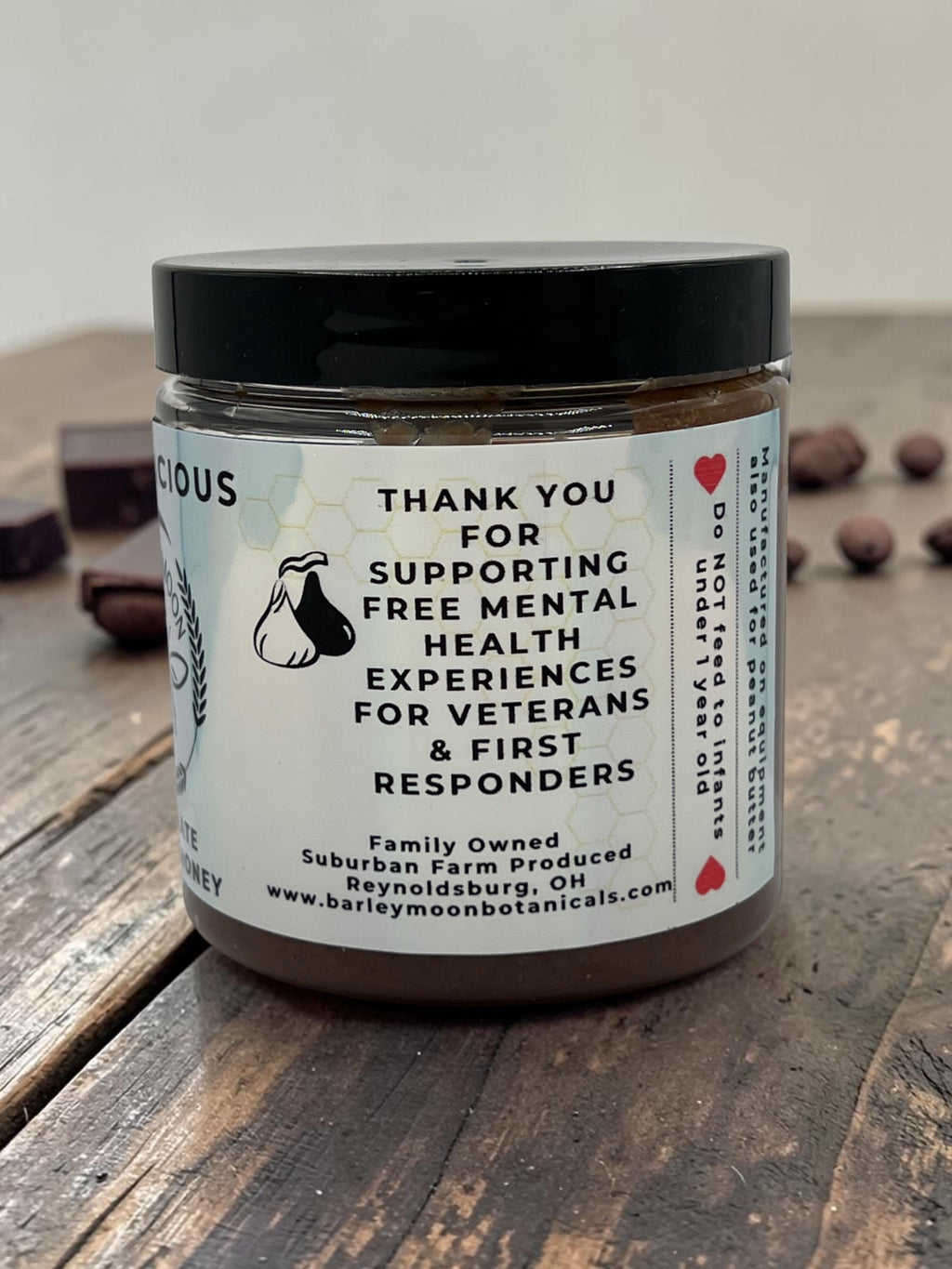 Barley Moon Botanicals Chocolicious chocolate creamed honey jar with a label highlighting support for veterans.