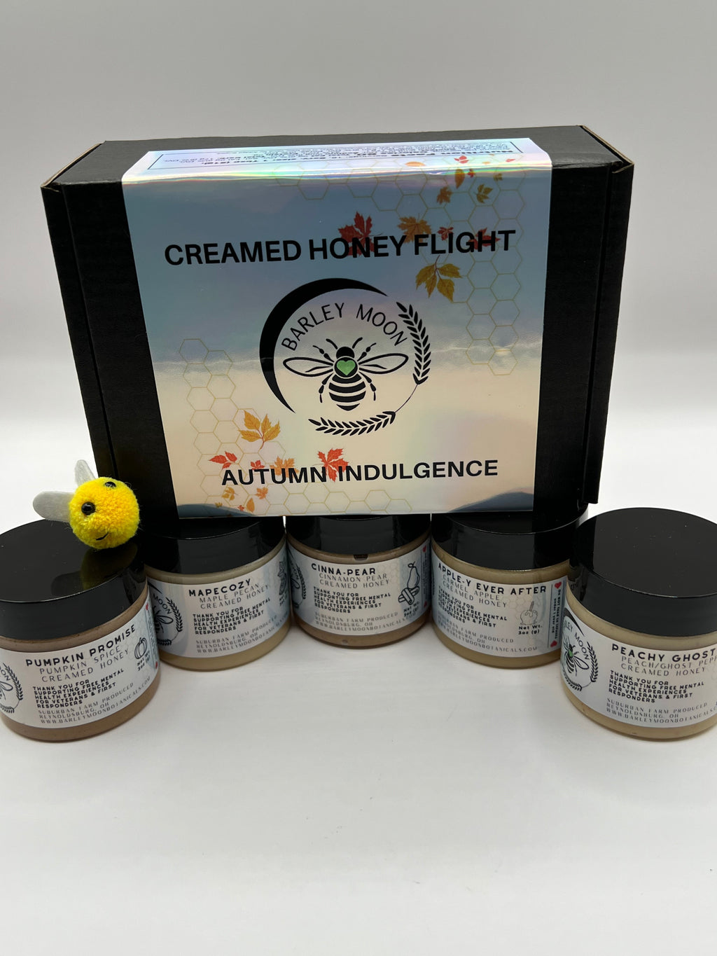 Barley Moon Botanicals Autumn Indulgence creamed honey flight set with five jars and a small decorative felt bee.