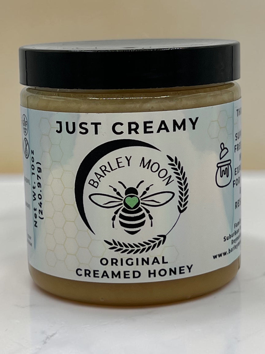 Barley Moon Botanicals Just Creamy original creamed honey in a glass jar with a black lid and bee logo label