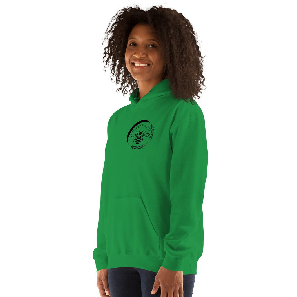 Barley Moon Botanicals green unisex hoodie featuring a black bee and crescent moon logo on a smiling woman