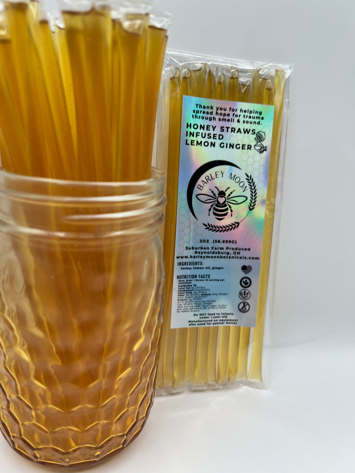 Barley Moon Botanicals Linger Zing lemon ginger honey straws in a glass jar with a holographic product label.