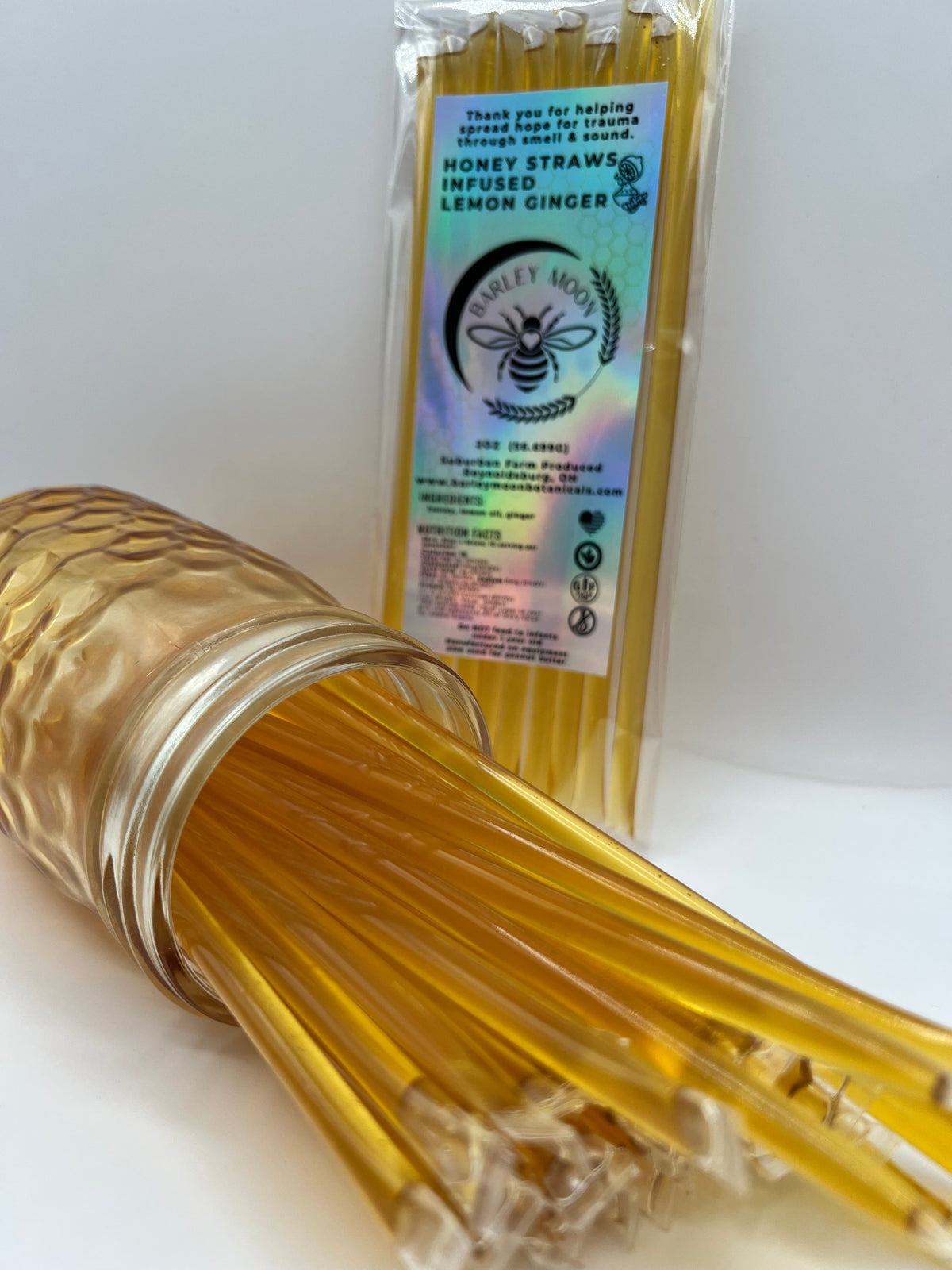 Barley Moon Botanicals lemon ginger honey straws in a glass jar with a holographic product label.