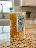 Barley Moon Botanicals Linger Zing lemon ginger honey straws in a glass jar and clear packaging on a kitchen counter.