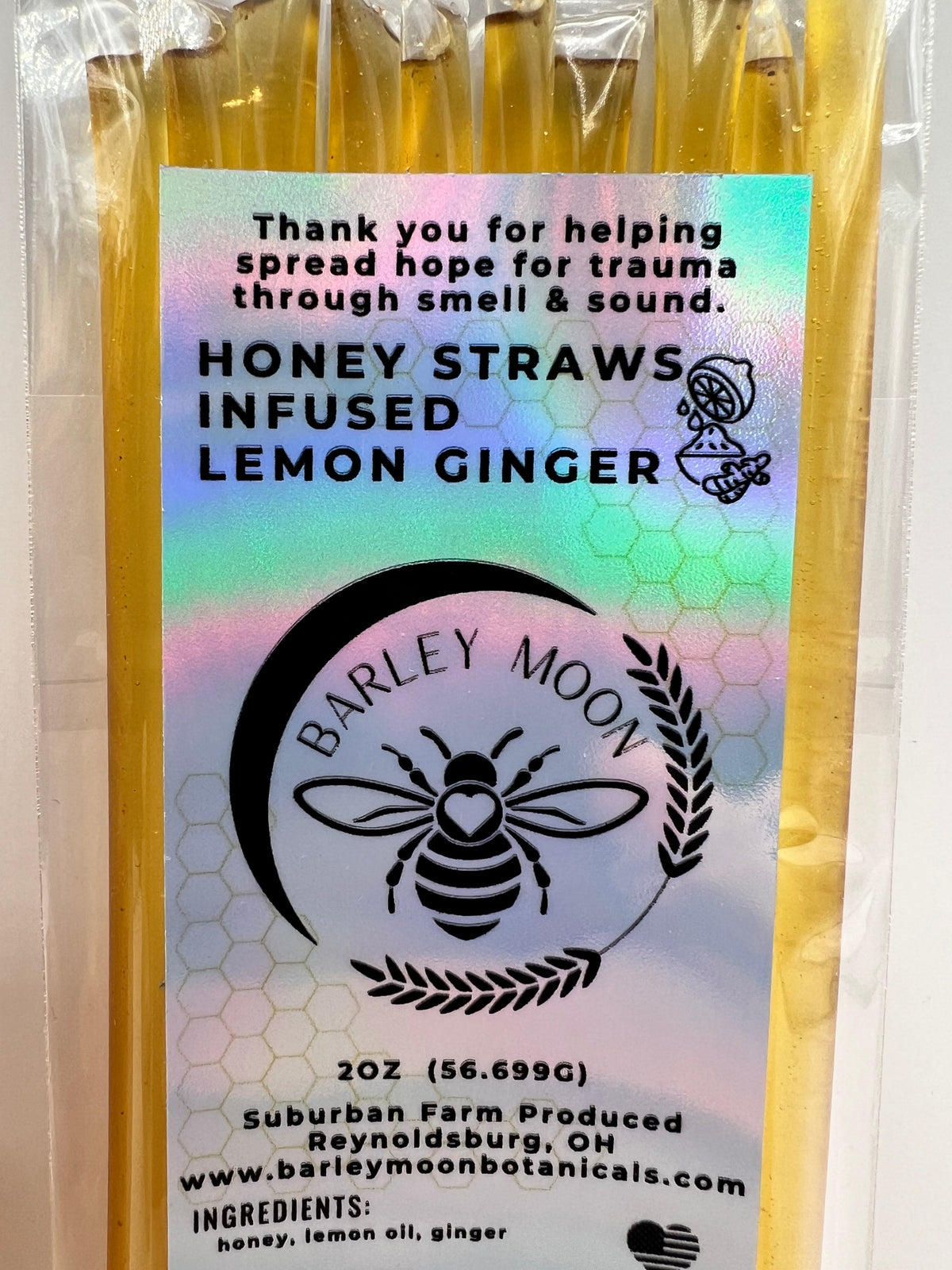 Barley Moon Botanicals Lemon Ginger honey straws in a clear, holographic label package for a zesty, natural treat.
