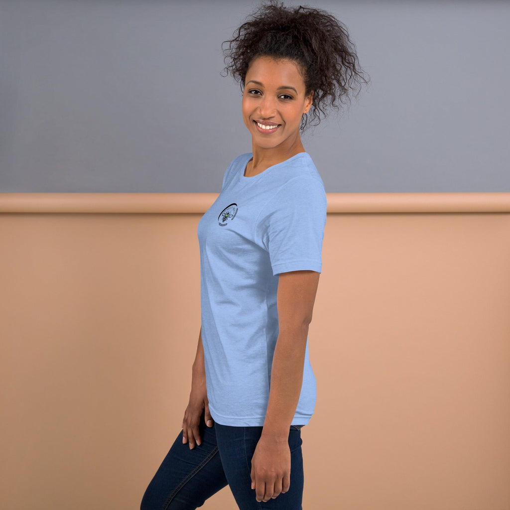 A woman wearing a light blue Barley Moon Botanicals t-shirt with a bee and crescent moon logo on the chest.