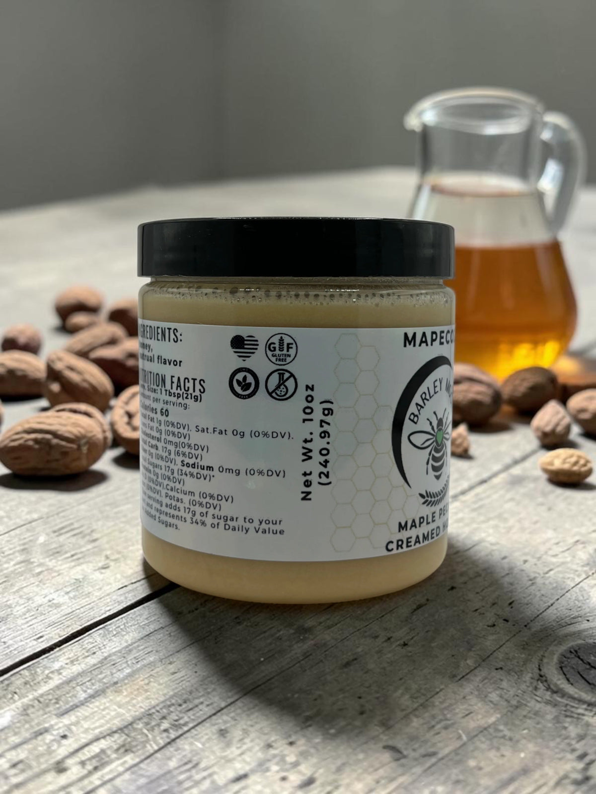 Barley Moon Botanicals MapeCozy creamed honey jar with maple and pecan, displayed on a rustic wooden table.