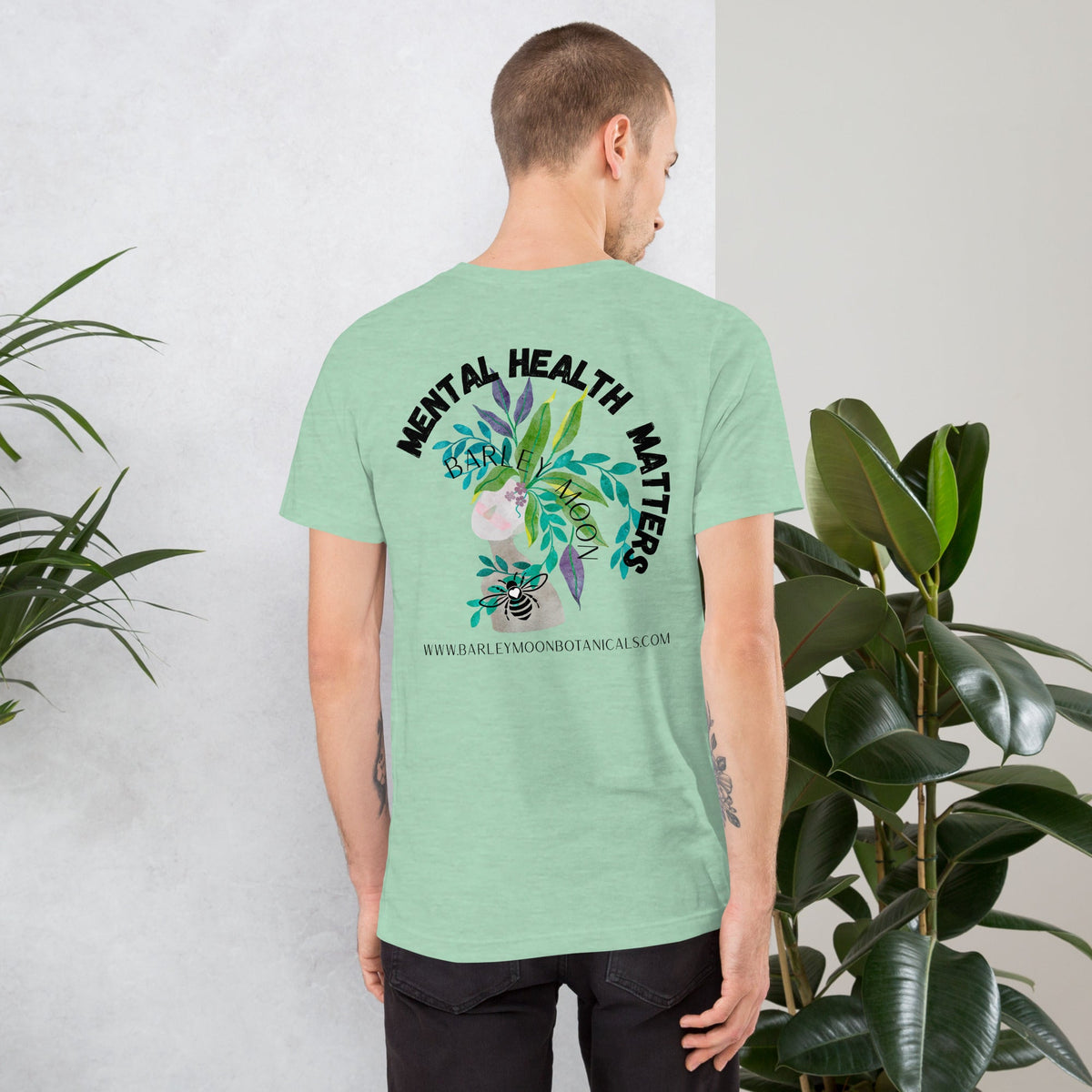 Barley Moon Botanicals unisex t-shirt in light green featuring Mental Health Matters botanical bee graphic on the back