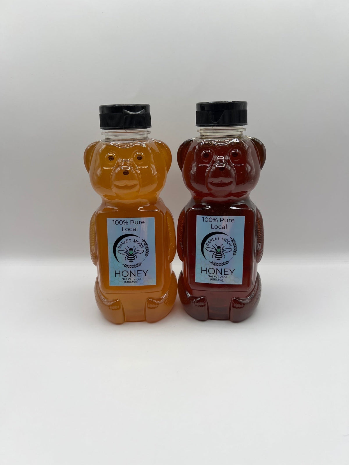 Barley Moon Botanicals raw local honey in two 24 oz bear-shaped plastic bottles with light and dark amber honey