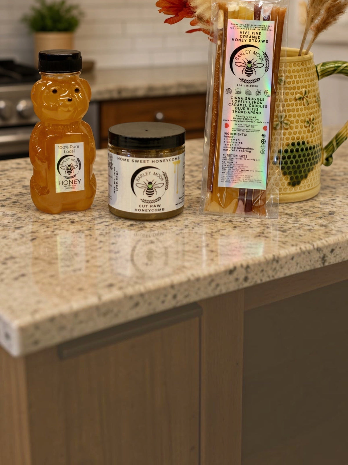 Barley Moon Botanicals raw honey bundle featuring a honey bear, jar of honeycomb, and pack of creamed honey straws