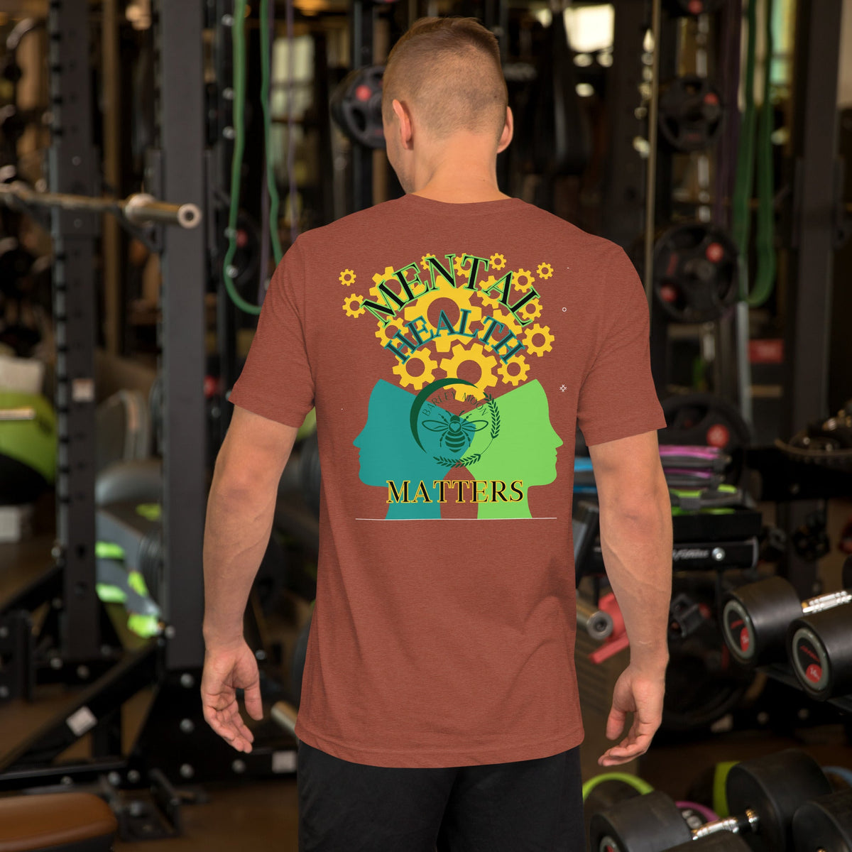 Barley Moon Botanicals unisex t-shirt in rust red featuring a mental health graphic with gears and a bee design.