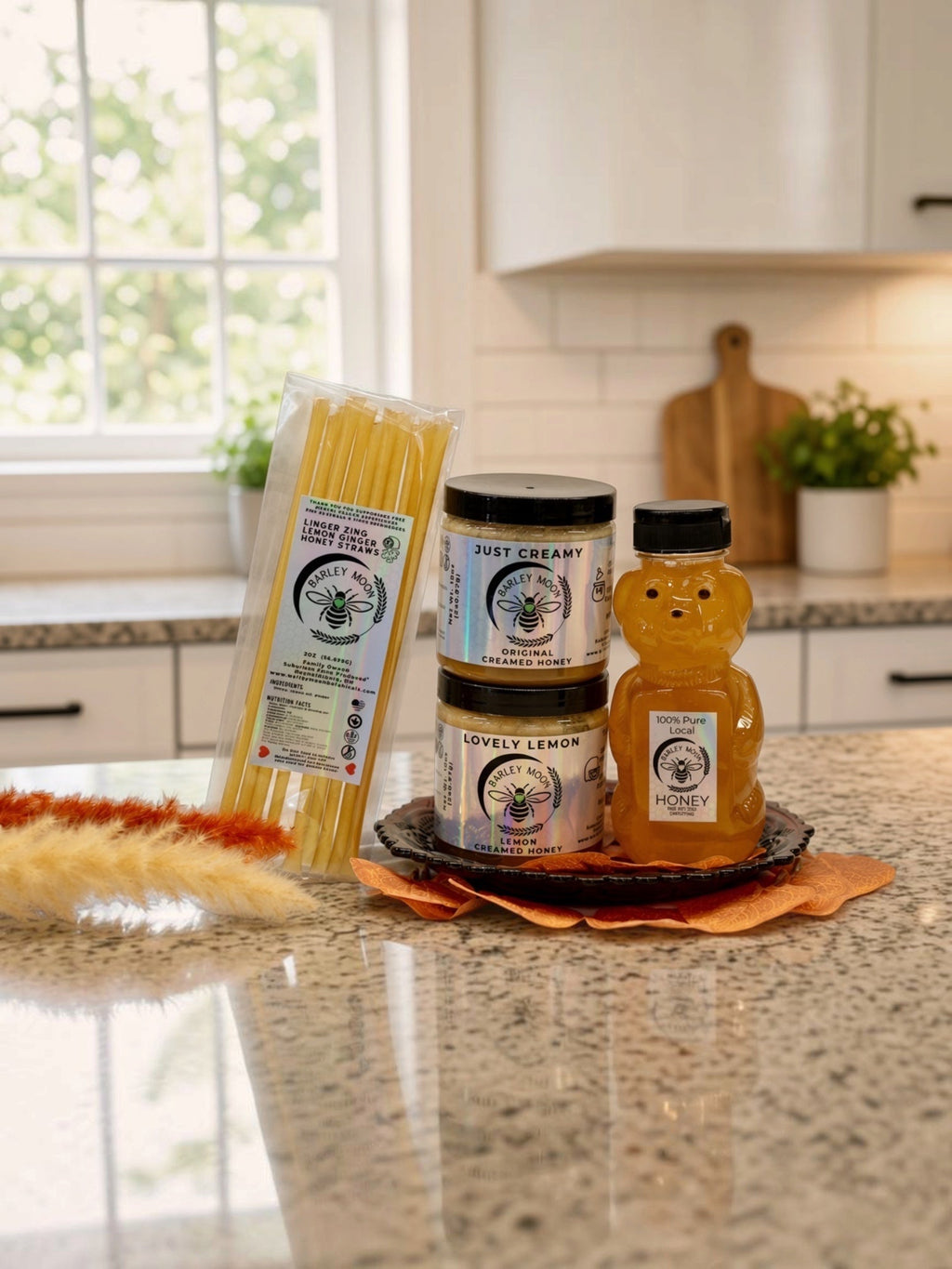 Barley Moon Botanicals Tea Lover Bundle featuring creamed honey jars, a honey bear, and lemon ginger honey straws.