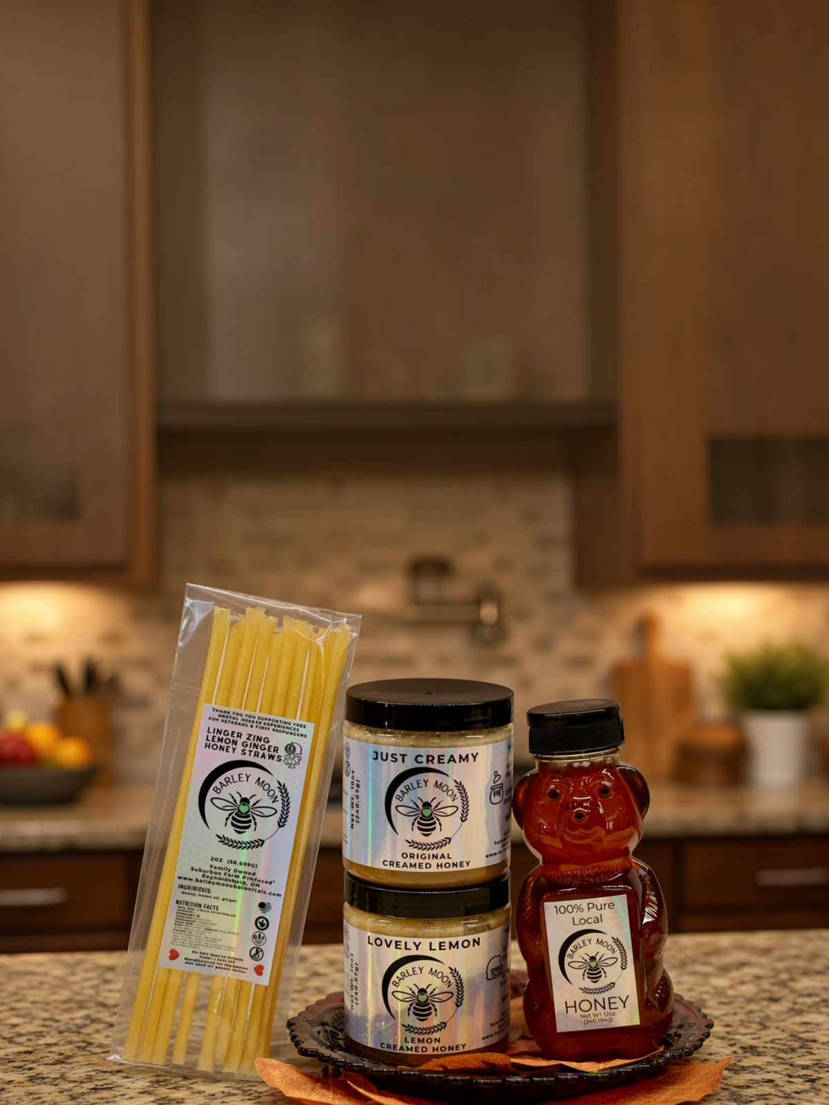 Barley Moon Botanicals Tea Lover Bundle featuring creamed honey jars, a honey bear, and lemon ginger honey straws.