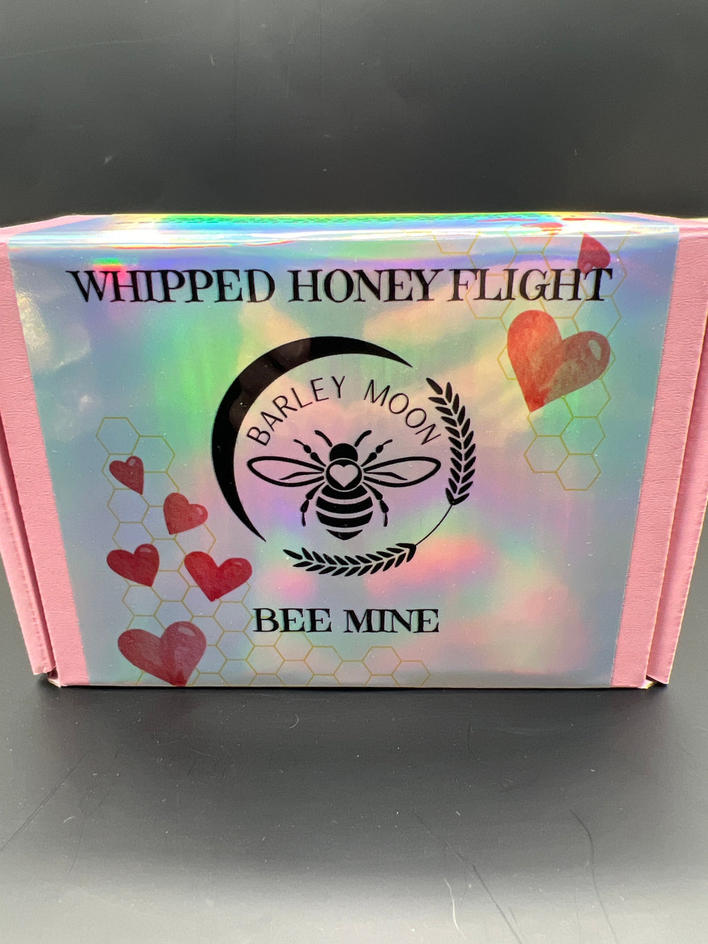 Barley Moon Botanicals Bee Mine Whipped Honey Flight box with iridescent finish and heart illustrations.