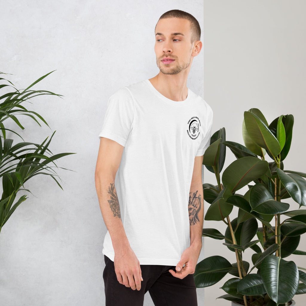 Model wearing a white Barley Moon Botanicals unisex t-shirt with a small circular bee logo on the chest.