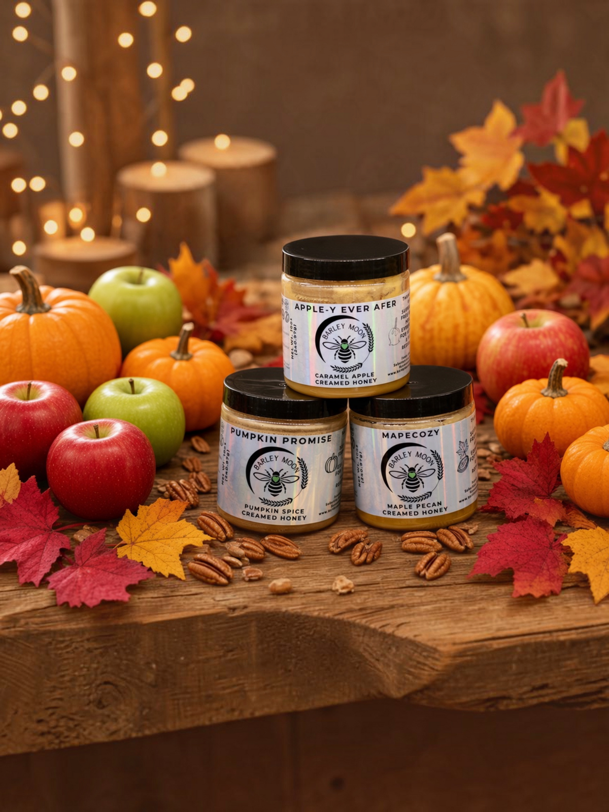Barley Moon Botanicals Cozy Fall Trio of creamed honey jars surrounded by pumpkins, apples, and autumn leaves.